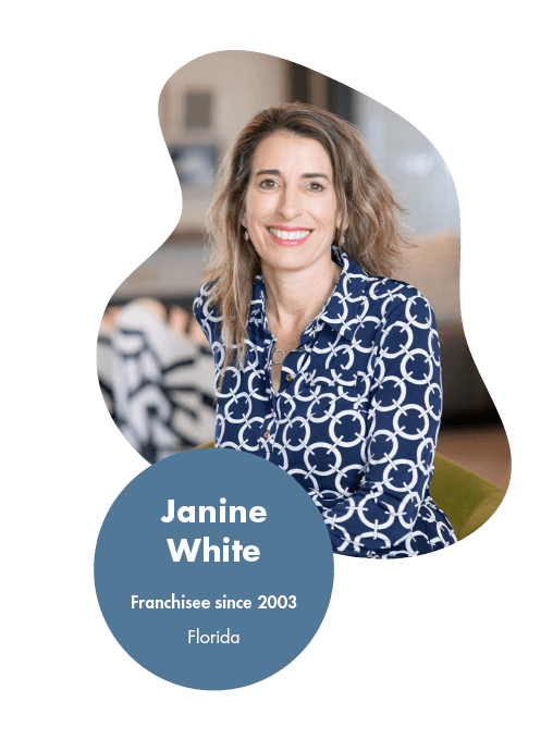 Janine White - Logistics Franchise Opportunity Reviews and Testimonials A woman with shoulder-length hair smiles while sitting indoors, dressed in a blue patterned blouse. Text overlay reads: Janine White, Franchisee since 2003, Florida. Known for her glowing franchise reviews by owners.