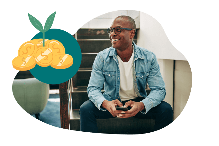 Franchise_WhyUni_Benefits_5050_4 A man in a denim jacket sits on stairs, smiling with a phone in hand. Nearby, an illustration of coins with a plant sprouting from them symbolizes financial growth or the best franchise opportunities for investment.
