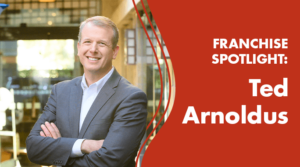 A smiling man in a suit stands with arms crossed next to text that reads: Franchise Spotlight: Ted Arnoldus on a red background.