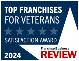 A blue and white badge reads: Top Franchises for Veterans Satisfaction Award 2024, with five stars—recognizing Unishippers Franchise Ownership—and Franchise Business Review in red and black text at the bottom right.
