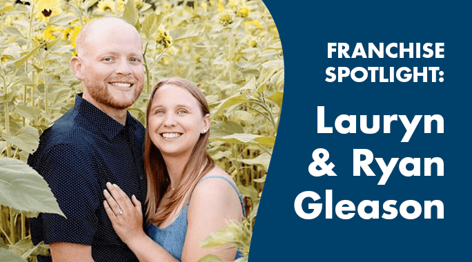 A smiling couple stands in a sunflower field. To the right, text on a blue background reads: FRANCHISE SPOTLIGHT: Lauryn & Ryan Gleason.