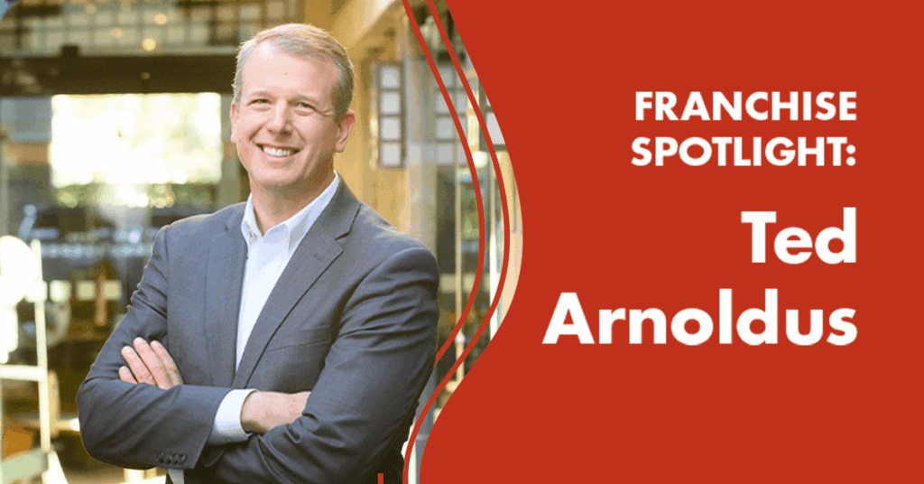 A man in a suit stands with arms crossed, smiling. Text on a red background reads: FRANCHISE SPOTLIGHT: Ted Arnoldus. The setting appears to be a modern restaurant or café.