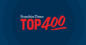 Logo with the words Franchise Times TOP 400 in white and bold red text on a dark blue background, highlighting its recognition as a Top 100 Franchise for Women.